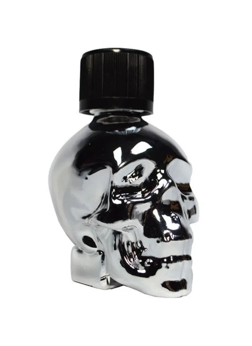 Metallic sculpture of a skull with a lid of a poppers bottle resting on top