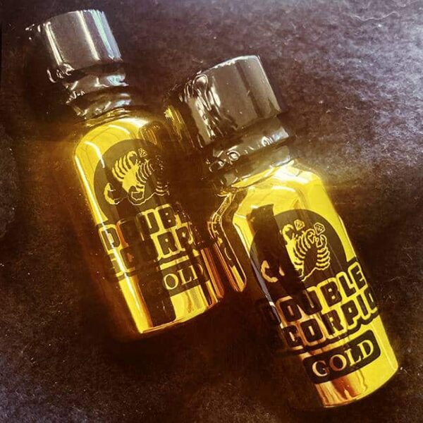 Two small bottles of double scorpio gold - 10ml poppers on a dark surface.